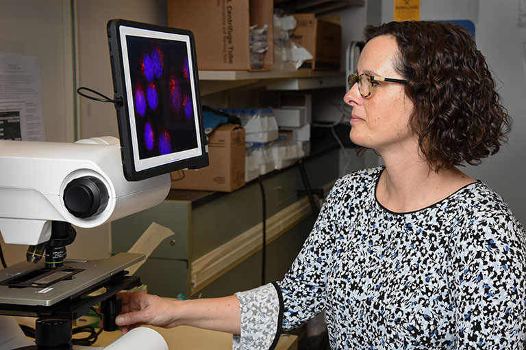 Rachel Katzenellenbogen, MD, demonstrating a REVOLVE microscope.